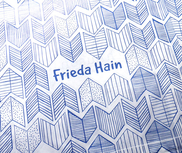 Close-up photo of a store bag pattern featuring a repeated stretched chevron design. Each chevron is filled with a different texture—some with dots, others with horizontal or vertical lines, and some with lines that follow the chevron's shape.